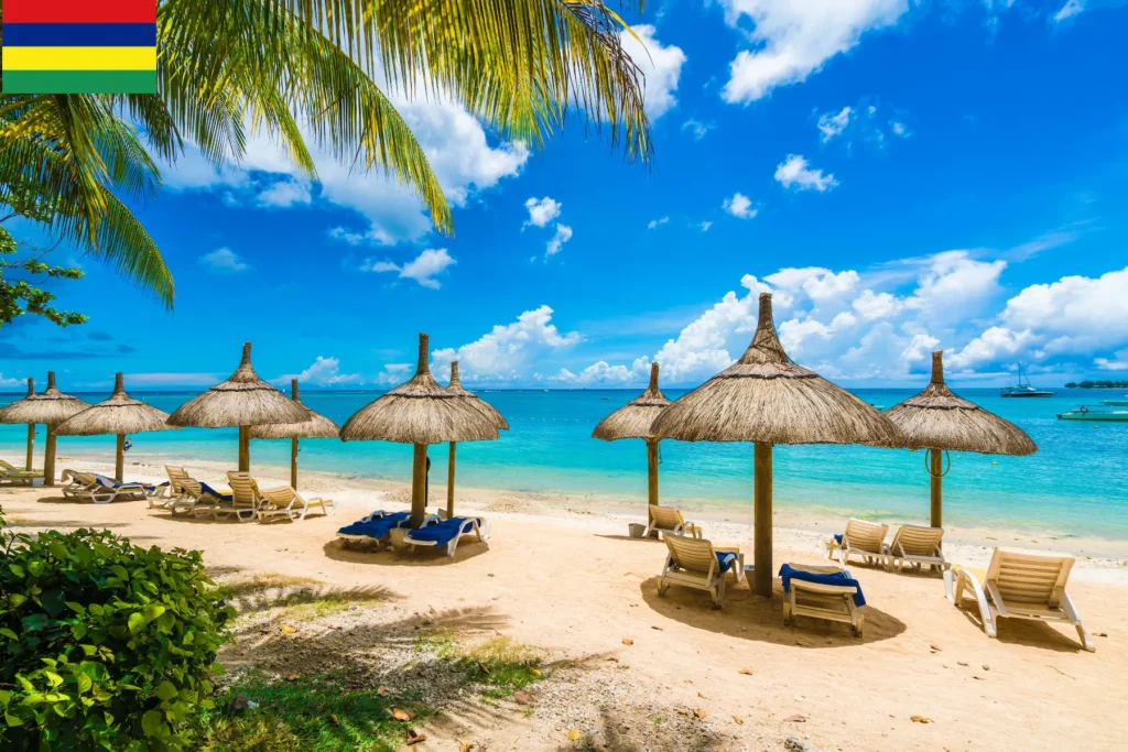White sandy beach with thatched umbrellas in Mauritius.