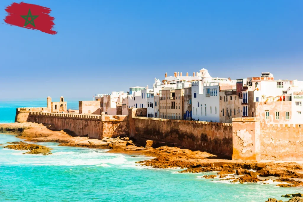 Coastal city view of Morocco with historic buildings along the shore.