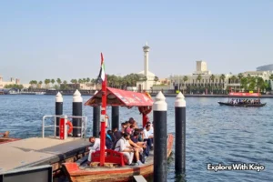 Passengers boarding an abra boat at Dubai Creek station in front of Dubai’s skyline