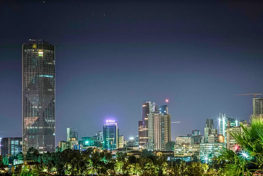 Night view of Addis Ababa, the capital city of Ethiopia, with modern skyscrapers and city lights Caption: “The vibrant skyline of Addis Ababa, Ethiopia’s capital and one of Africa’s fastest-growing cities.”
