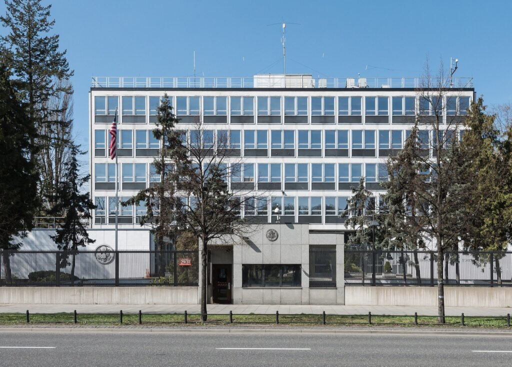 American flag flying in front of the United States Embassy building in Warsaw, Poland.