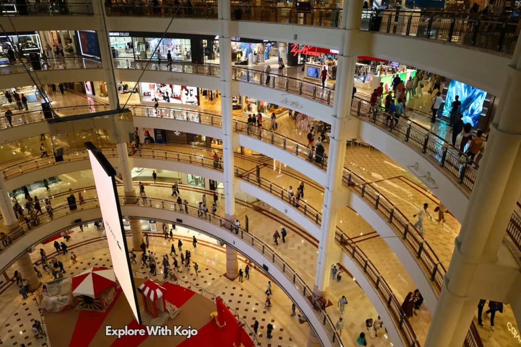Atrium overview of Suria KLCC Mall with shoppers.