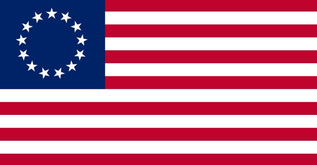 The Betsy Ross flag with 13 stars in a circle and 13 red and white stripes, representing the original American colonies.
