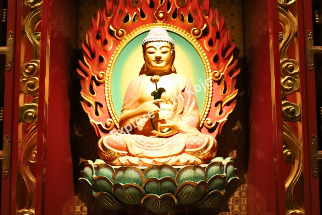 Golden Buddha statue with a red flame halo inside the Buddha Tooth Relic Temple.