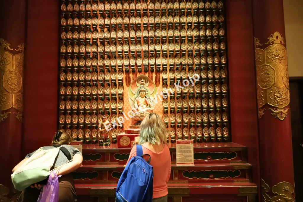 Corridor filled with golden statues at Buddha Tooth Relic Temple.