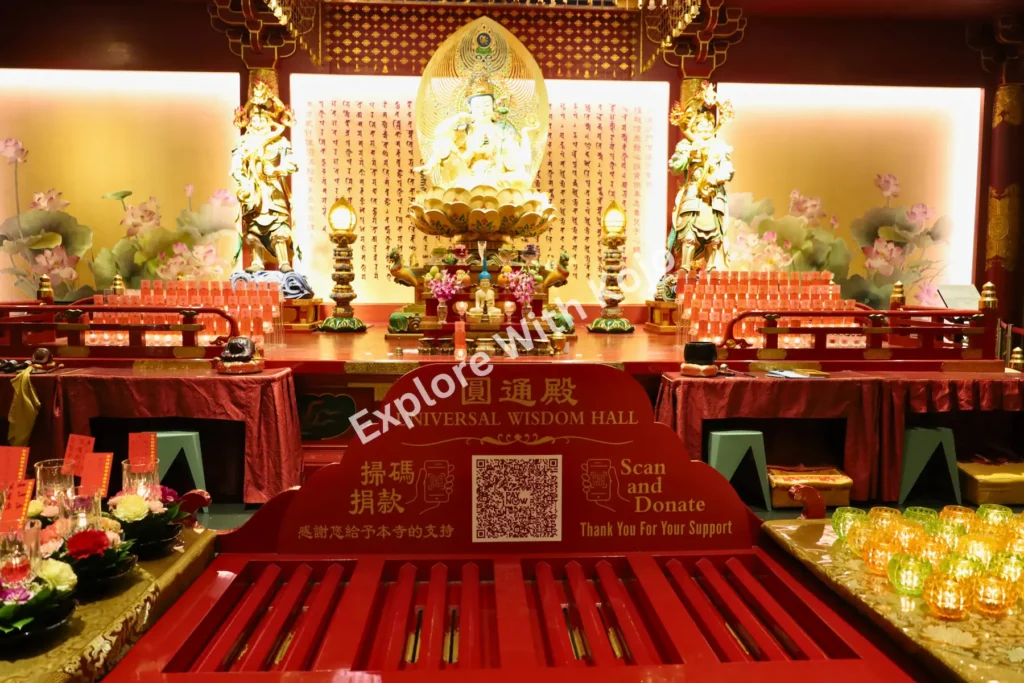 Main altar inside the Buddha Tooth Relic Temple in Singapore with golden statues and offerings.