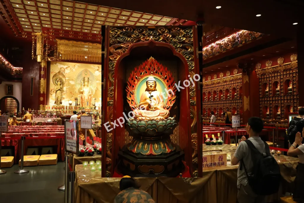 Worshippers inside the main prayer hall of the Buddha Tooth Relic Temple in Singapore.