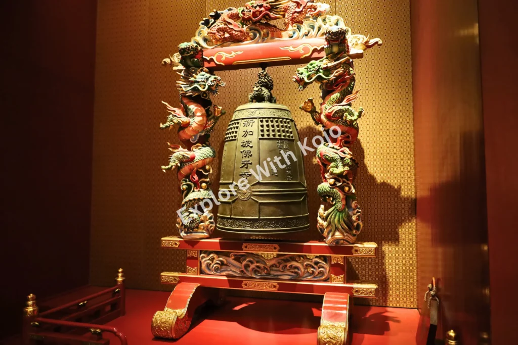 Ornate ceremonial bell on display inside Buddha Tooth Relic Temple.