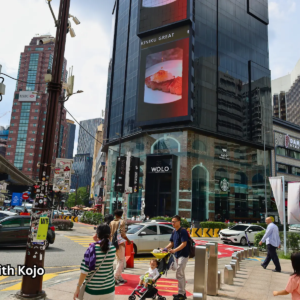 Busy Bukit Bintang crossing in Kuala Lumpur with people and traffic