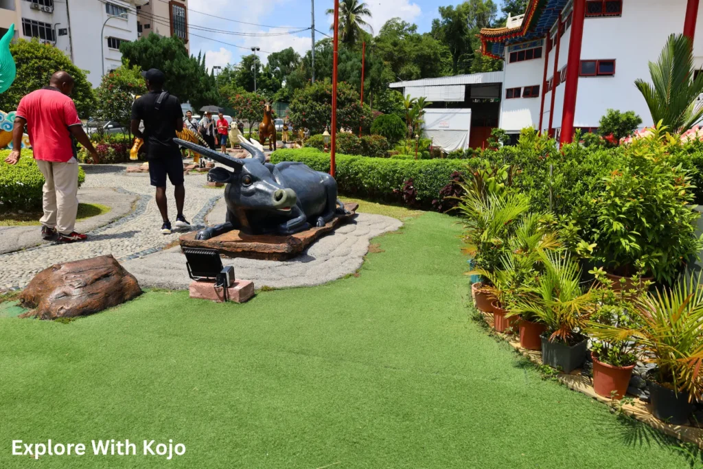 Visitors viewing Chinese zodiac sculptures in the garden at Thean Hou Temple, Kuala Lumpur.