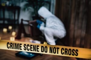 Crime scene tape with forensic investigator examining evidence inside a house after a violent shooting incident