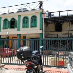 Heritage shophouses along a Kuala Lumpur street under renovation