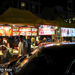 Street food stalls glowing at Jalan Alor Night Market in Kuala Lumpur