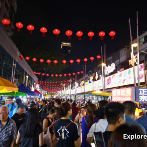 Red lanterns hanging above Jalan Alor street food market at night