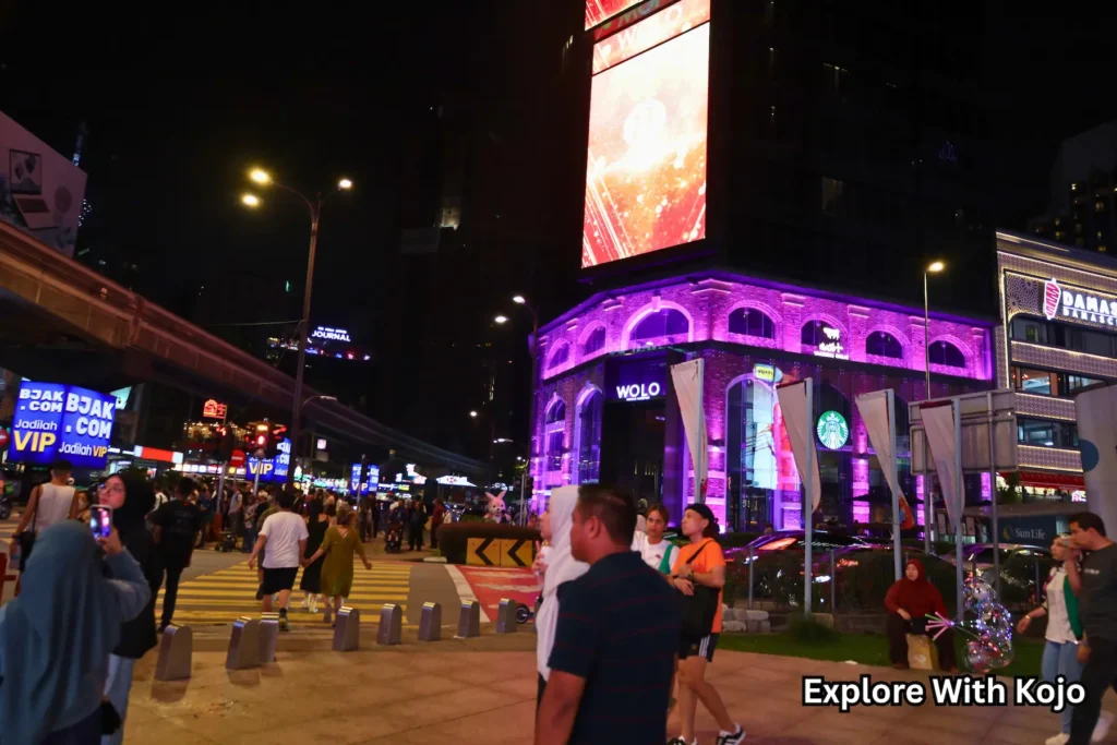 Neon-lit buildings along Jalan Bukit Bintang in Kuala Lumpur at night
