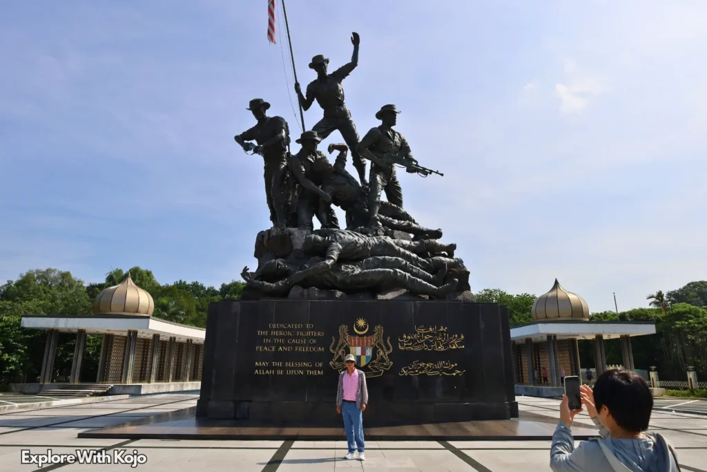 Visitors taking photos at the National Monument in Kuala Lumpur, Malaysia