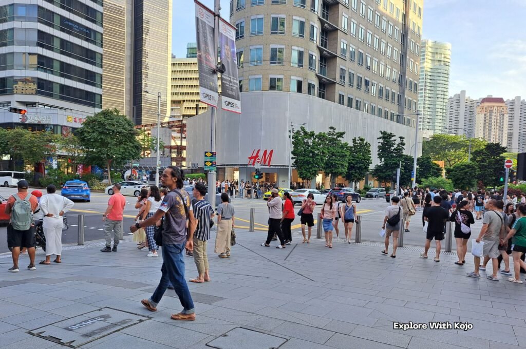 Crowds walking safely across Orchard Road in Singapore, one of the world’s safest and most exciting travel destinations.