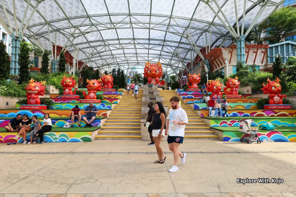 Colorful flower display inside Gardens by the Bay with visitors walking through.