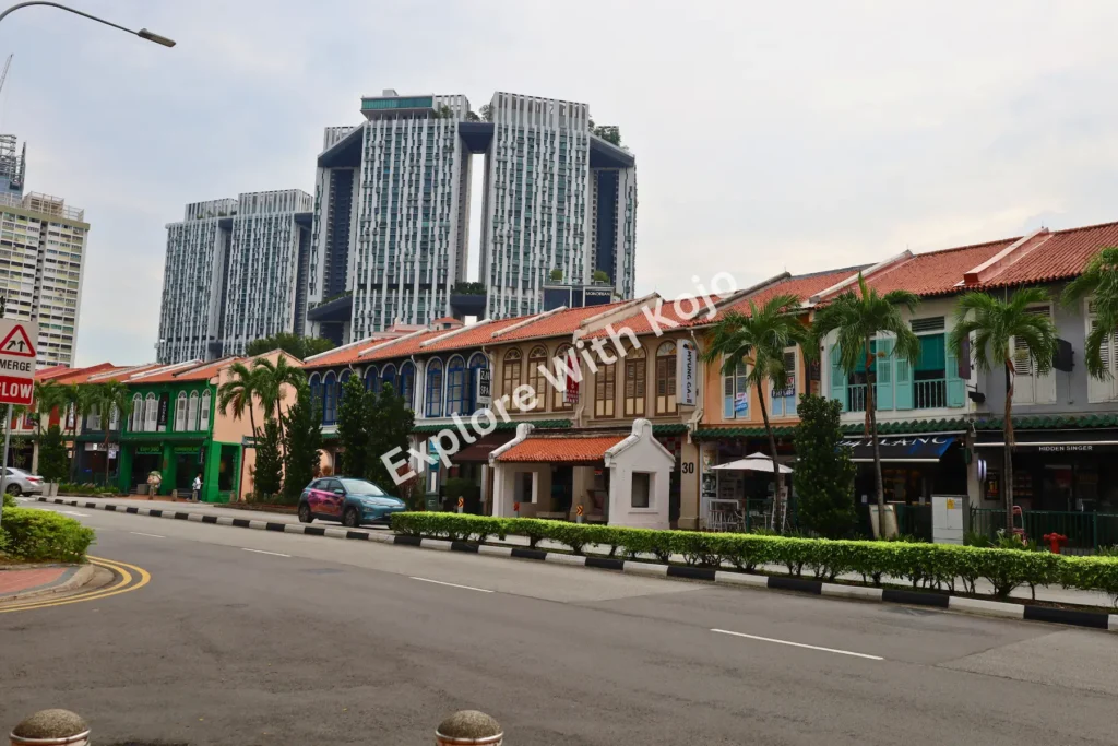 Traditional shophouses with modern skyscrapers in Singapore’s skyline.