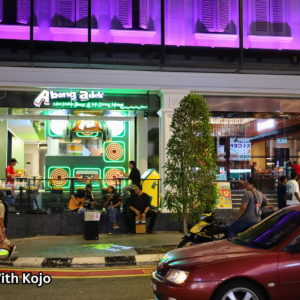 Starbucks in Bukit Bintang lit up at night with cars parked in front