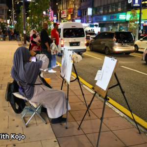 Street artist sketching portraits at Bukit Bintang Kuala Lumpur