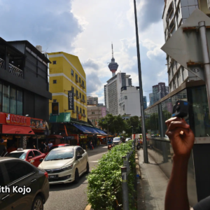 Street in Kuala Lumpur with KL Tower visible in the background