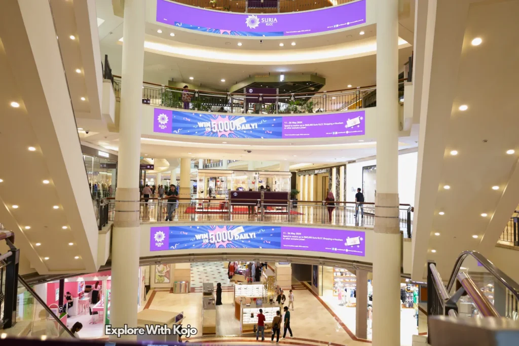 Expansive atrium at Suria KLCC Mall with lively activity.