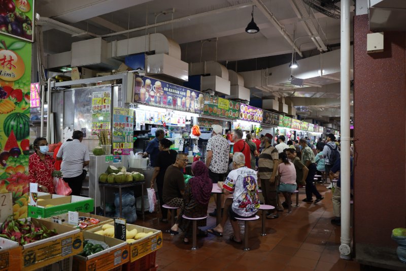 Crowded food stalls and diners inside Tekka Centre hawker market in Little India, Singapore.
