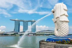 The iconic Merlion statue in Singapore spouting water with Marina Bay Sands in the background