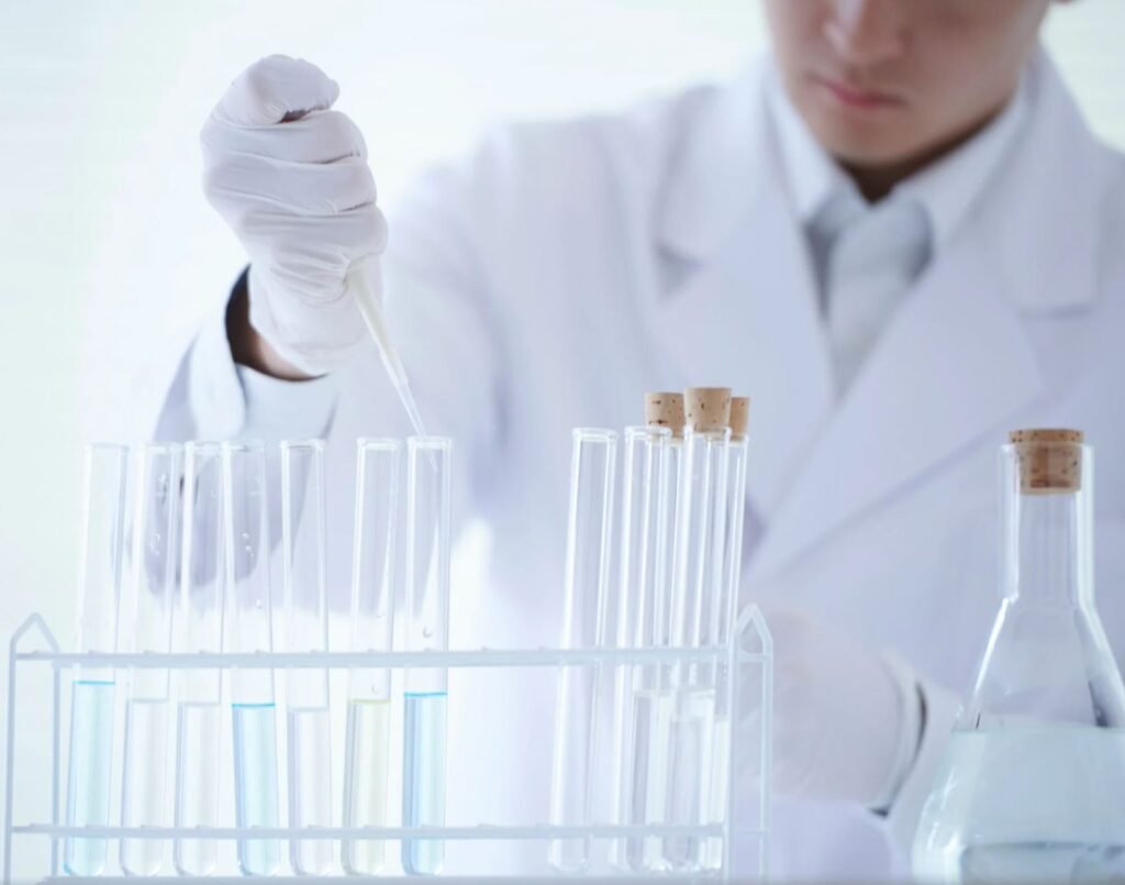 Scientist in a lab coat testing urine samples