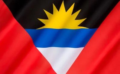 Flag of Antigua and Barbuda with a rising sun over blue, white, and red.