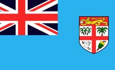 Flag of Fiji with light blue field, Union Jack, and national shield emblem.