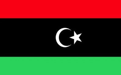 Flag of Libya with red, black, and green stripes and white crescent and star.
