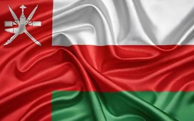 Flag of Oman with white, red, and green horizontal bands and national emblem.