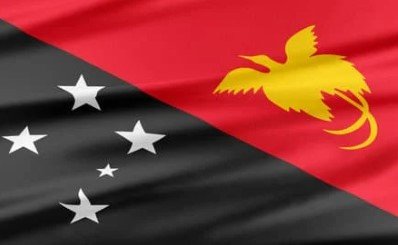 Flag of Papua New Guinea with black and red triangles, yellow bird of paradise, and white stars.