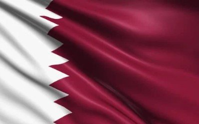 Flag of Qatar with maroon field and white serrated band.