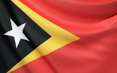 Flag of Timor-Leste with red field, black and yellow triangles, and white star.