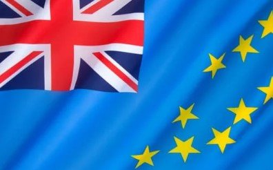 Flag of Tuvalu with light blue field, Union Jack, and nine yellow stars.