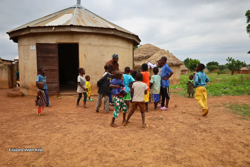 Children playing together in an African village compound.