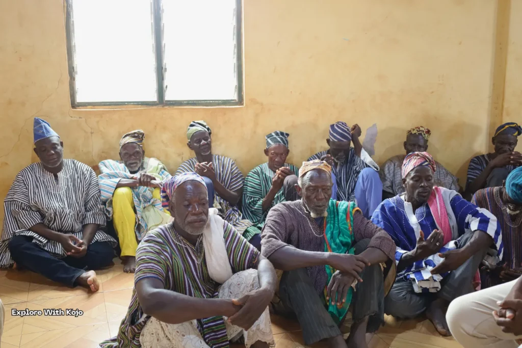 Elder men gathered indoors for a discussion.