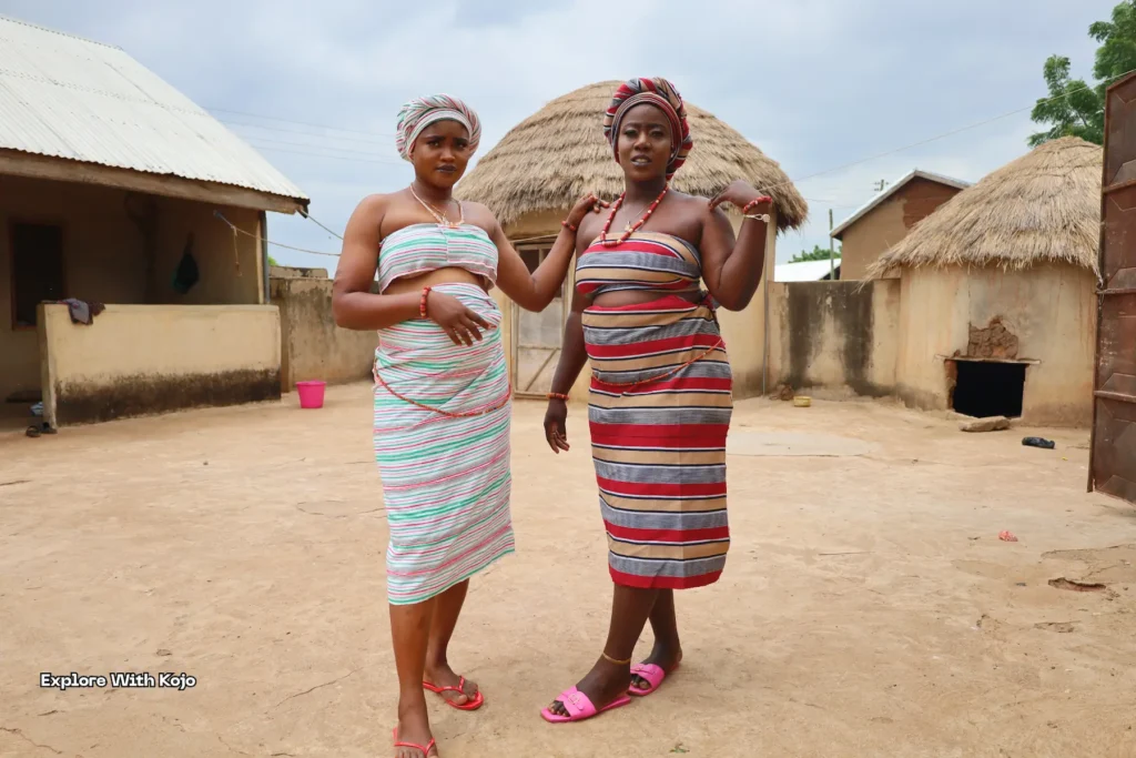 Two young women smiling in traditional African wrappers.
