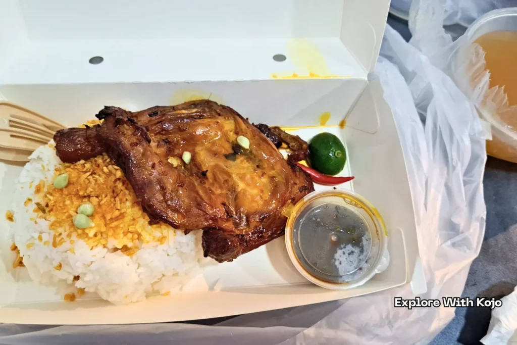 Grilled chicken and rice packed in a takeaway box for a flight meal