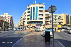 Deira Dubai street scene with older apartment blocks and shops. This is an affordable place that is metro-connected