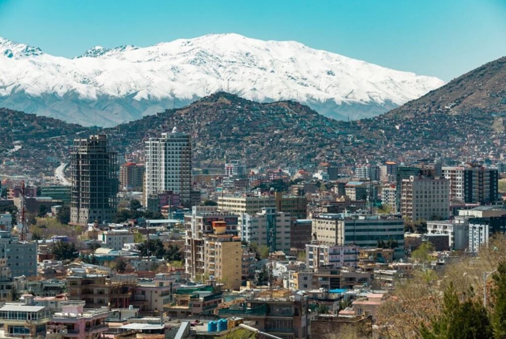 Cityscape of Kabul, Afghanistan with snow-capped mountains in the background, showing the country’s mix of beauty and hardship