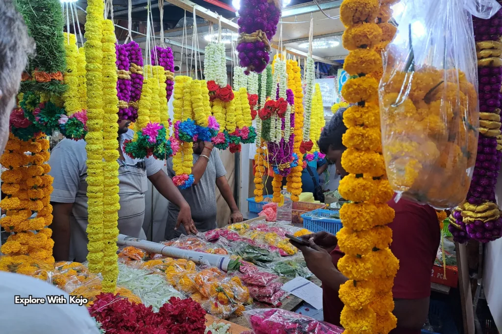 Close-up of hanging marigold and jasmine garlands at Deepavali flower stall Singapore.