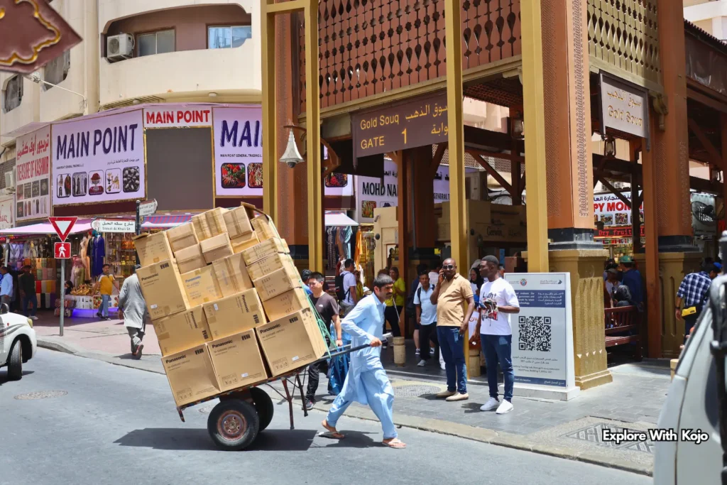 Workers and shoppers at the entrance of Dubai’s Gold Souk