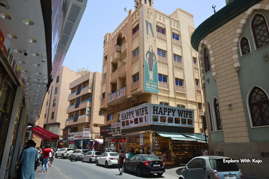 Street view in Deira showing Happy Wife shops and traditional architecture