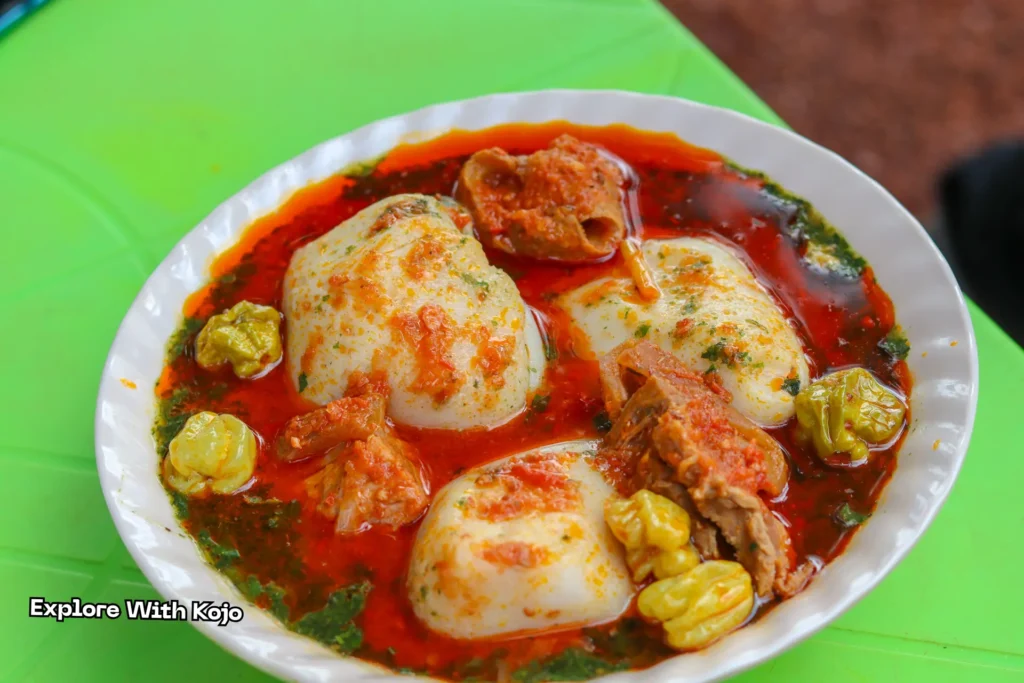 A man enjoying tuo zaafi at a roadside food stall in Ghana.