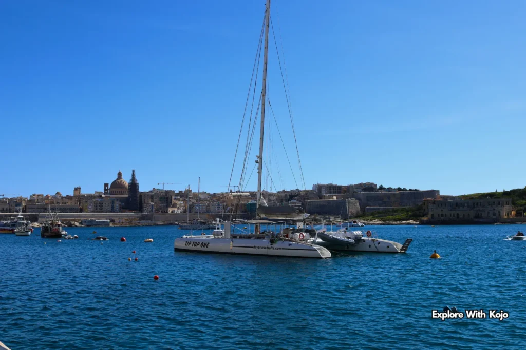 Yacht on Malta’s Grand Harbour with historic skyline