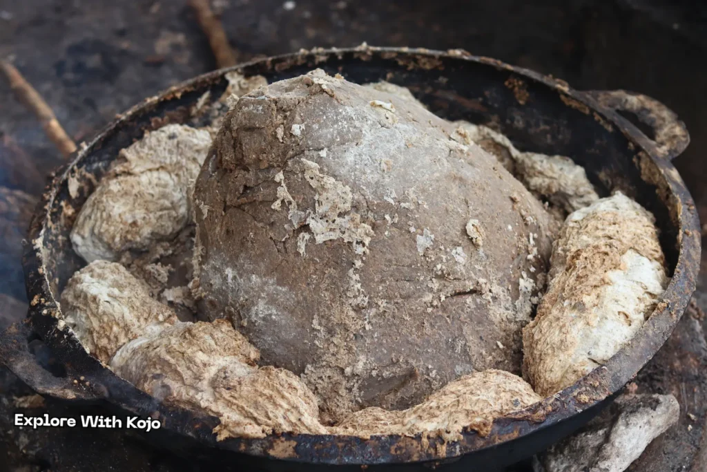 African black soap mixture being heated in a metal pot in Tamale, Ghana